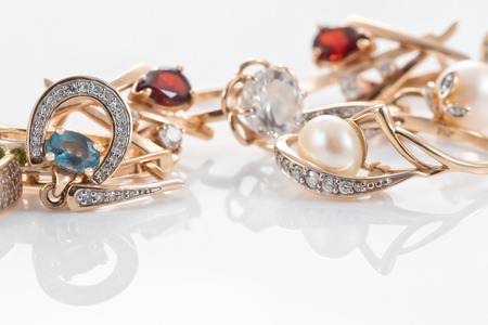A variety of gold jewelry : rings, earrings with Topaz and pearlsの写真素材
