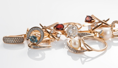 A variety of gold jewelry : rings, earrings with Topaz and pearlsの写真素材