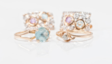 Two gold rings with Topaz and diamond set of earrings with small gemstonesの写真素材