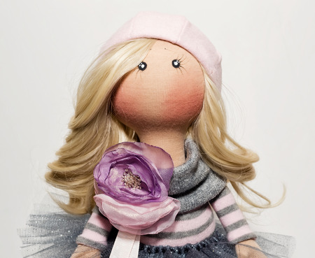 Handmade doll with natural hair in a pink beret and a lush skirt with sequinsの写真素材