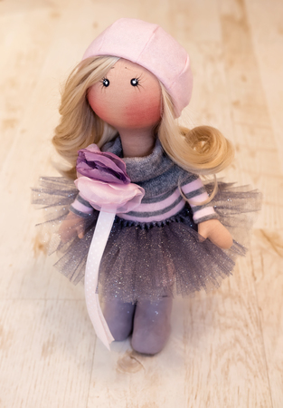 Handmade doll with natural hair in a pink beret and a lush skirt with sequinsの写真素材