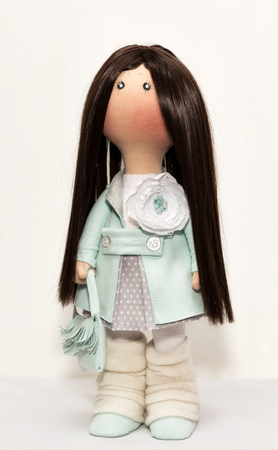 Rag doll handmade with a natural dark hair with a graceful handbag in handsの写真素材