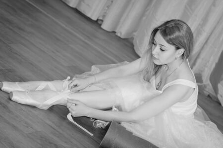 Charming young dancer wears special shoes with strings - Pointe shoesの写真素材