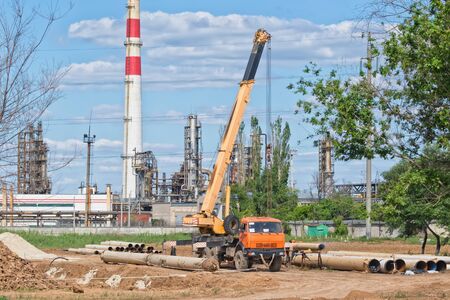 Welding near an oil refinery on the large diameter pipeline with the use of the craneの写真素材