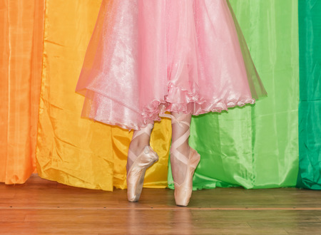 Slender legs of a ballerina clad in Pointe shoes, standing on toes closeupの写真素材