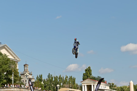 VOLGOGRAD - SEPTEMBER 9: Tricks on a motorcycle jump performed by the athletes during the first championship of Russia on freestyle motocross. September 29 2017 in Volgograd Russia.のeditorial素材