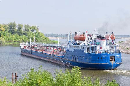 VOLGOGRAD - SEPTEMBER 16: Barge for transportation of various petroleum products turns out of the shipping channel into the channel of the Volga. September 16, 2017 in Volgograd, Russia.のeditorial素材