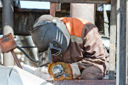 Welder in the mask processes, the weld seam grinding machineの写真素材
