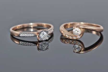 different a gold ring lying next to each otherの写真素材