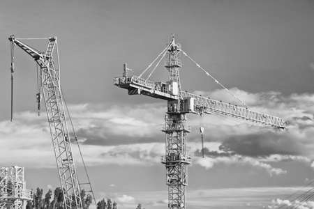 A large tower construction crane involved in the construction of monolithic houses. Black and white photoの写真素材