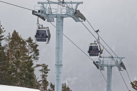 Ski lift cabins in snow storm with low visibilityの写真素材
