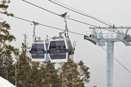 Ski lift cabins in snow storm with low visibilityの写真素材