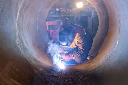 Welding works in severe conditions-inside the case of the device in conditions of strong smokeの写真素材