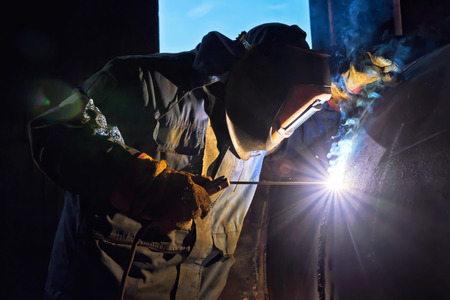 Welding works manual arc welding in the repair of chemical apparatus in a protective mask and...