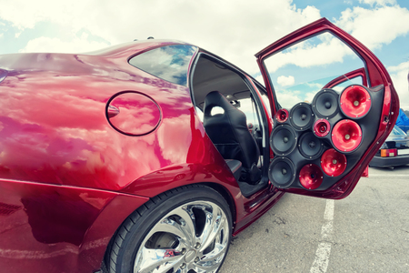 car with a large number of installed audio speakers and subwoofer