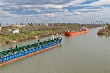 VOLGOGRAD, RUSSIA - APRIL 29: Large river barges for transportation of oil products swim through the navigable Volga-don canal. April 29, 2018  in Volgograd, Russia.のeditorial素材