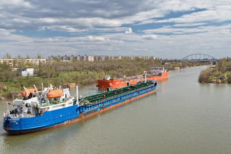 VOLGOGRAD, RUSSIA - APRIL 29: Large river barges for transportation of oil products swim through the navigable Volga-don canal. April 29, 2018  in Volgograd, Russia.のeditorial素材