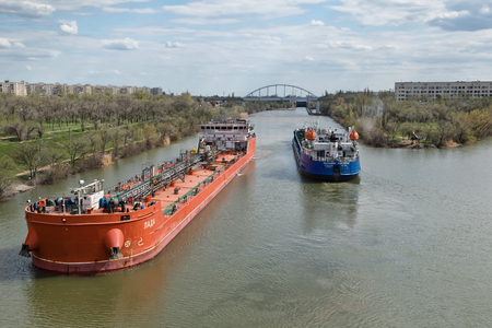 VOLGOGRAD, RUSSIA - APRIL 29: Large river barges for transportation of oil products swim through the navigable Volga-don canal. April 29, 2018  in Volgograd, Russia.のeditorial素材