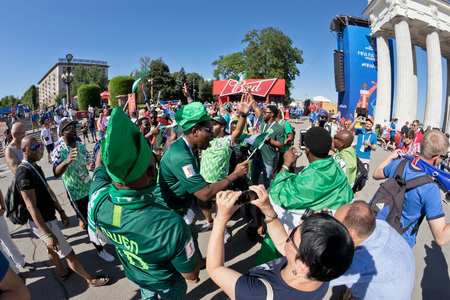 VOLGOGRAD - JUNE 22: Fans of the national team of Nigeria in t-shirts of the national team and national flags rest at the festival of ballet. June 22, 2016 in Volgograd, Russia.のeditorial素材