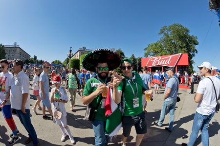 VOLGOGRAD - JUNE 22: Fans of the national team of Mexico dressed in sombrero and clothes in the colors of the national flag rest at the festival of balloonists. June 22, 2016 in Volgograd, Russia.のeditorial素材