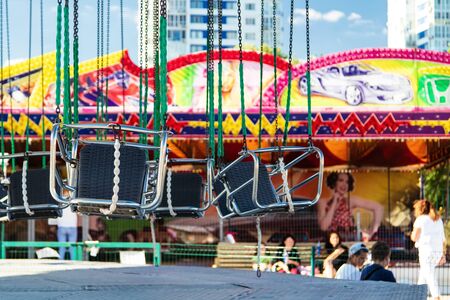 VOLGOGRAD, RUSSIA - SEPTEMBER 22: Swing seats hanging on long chains. Children's amusement Park. September 22, 2018  in Volgograd, Russia.のeditorial素材