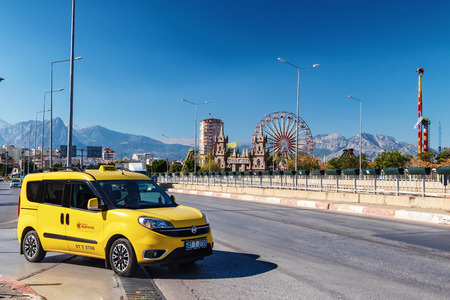 ANTALYA, TURKEY - NOVEMBER 16: Yellow street taxi Antalya on the background of the amusement Park with a Ferris wheel. November 16, 2018  in Antalya, Turkey.のeditorial素材