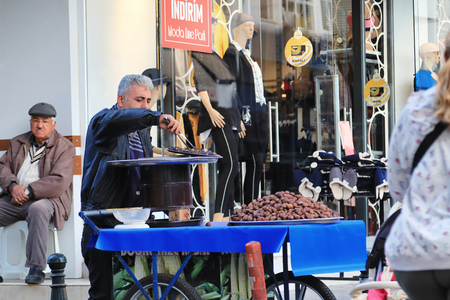 ANTALYA, TURKEY - NOVEMBER 16: Preparation of the local dealer in roasted chestnuts on the coals on the streets. November 16, 2018  in Antalya, Turkey.のeditorial素材