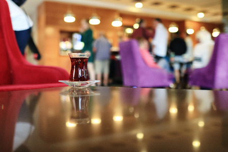A Cup of Turkish tea on a saucer is on the table in the restaurantの写真素材