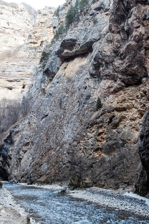 Wines of the slopes of the mountains and cliffs in a mountain gorge in winterの写真素材