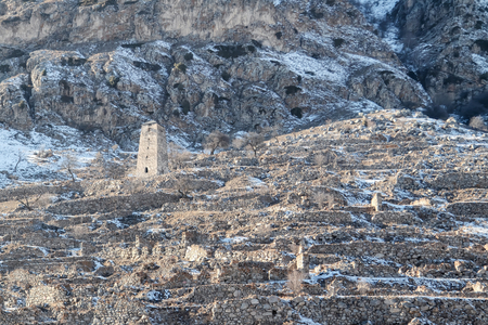 The ruins of an ancient mountain village with many fences built of stones without mortarの写真素材
