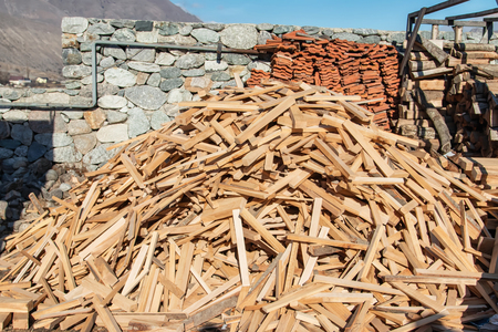 Stock of firewood for the winter is in the yard in the mountain villageの写真素材