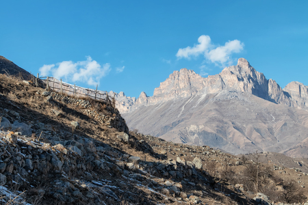 The ruins of an ancient mountain village with many fences built of stones without mortarの写真素材