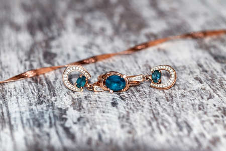 Set of gold jewelry with Topaz: ring and earrings in the shape of a horseshoeの写真素材