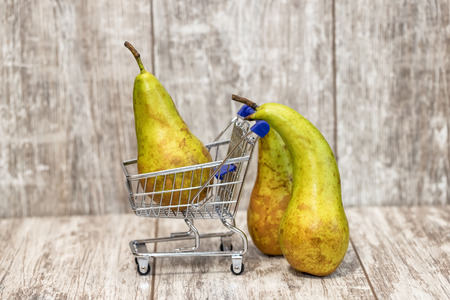 Abstraction : an old pear - parents wheeled a trolley from the supermarket with pear-childの写真素材