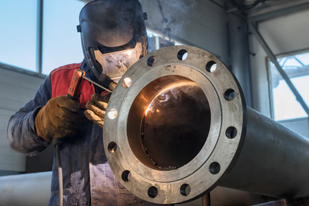 Welding works on production of the pipeline unit-welding of the pipe and thick-walled flangeの写真素材