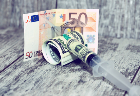 Injection syringe dollar mix in the Euro currencyの写真素材