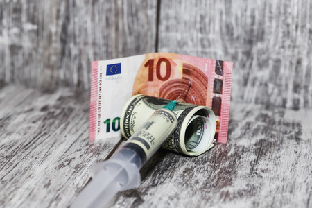 Injection syringe dollar mix in the Euro currencyの写真素材
