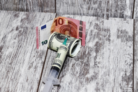 Injection syringe dollar mix in the Euro currencyの写真素材