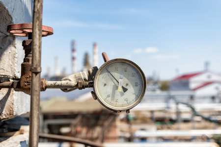 Pretty much worn , but properly working pressure gauge installed on the pipeline at the old chemical plantの写真素材
