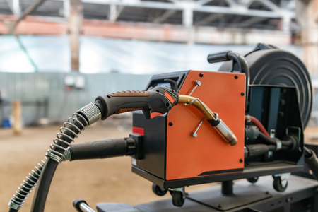 The device for semi-automatic welding in the environment of protective gases is in a spacious shop for the Assembly of metal structuresの写真素材