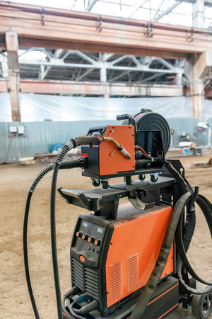 The device for semi-automatic welding in the environment of protective gases is in a spacious shop for the Assembly of metal structuresの写真素材