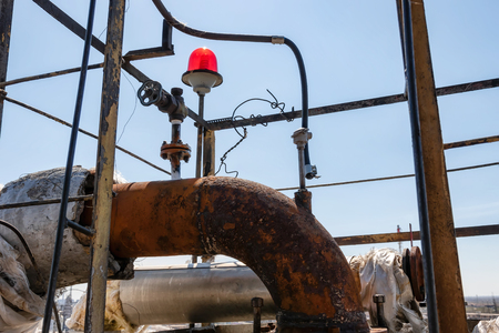 Old rusty process pipelines in an oil refineryの写真素材