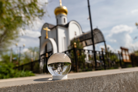 A small Orthodox chapel with a Golden dome and crosses . Photo taken through the lensballの写真素材