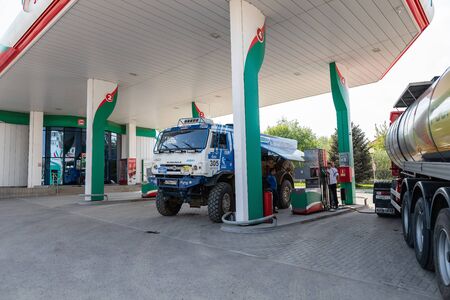 VOLGOGRAD - APRIL 28: Rally KAMAZ truck with the symbols of the sponsors is refilled at the filling stations of TATNEFT. April 28, 2019 in Volgograd, Russia.のeditorial素材