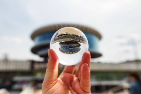 VOLGOGRAD - MAY 4: View on building of Volgograd river port in the form of a large washer of glass and concrete through lensball. May 4, 2019 in Volgograd, Russia.のeditorial素材