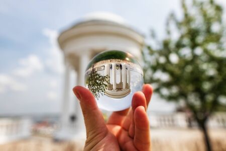 VOLGOGRAD - MAY 4: One of the attractions of the Central promenade of the city - rotunda after restoration. Photo taken through a crystal ball. May 4, 2019 in Volgograd, Russia.のeditorial素材