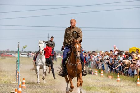 SMALL CHAPURNIKI, VOLGOGRAD, RUSSIA - JUNE 8: Demonstration performances of the Cossack equestrian sports club with the use of firearms. June 8, 2019 in Volgograd, Russia.のeditorial素材