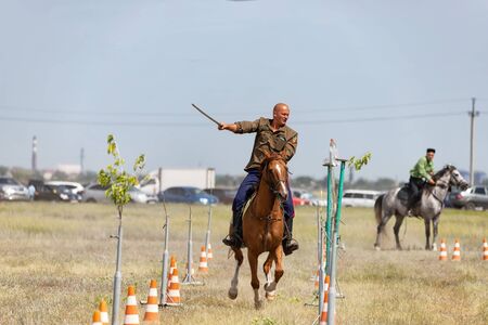 SMALL CHAPURNIKI, VOLGOGRAD, RUSSIA - JUNE 8: Demonstrations Cossack equestrian sports club with a demonstration of possession of a combat sword. June 8, 2019 in Volgograd, Russia.のeditorial素材