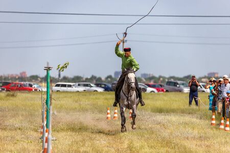 SMALL CHAPURNIKI, VOLGOGRAD, RUSSIA - JUNE 8: Demonstrations Cossack equestrian sports club with a demonstration of possession of the whip. June 8, 2019 in Volgograd, Russia.のeditorial素材