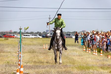 SMALL CHAPURNIKI, VOLGOGRAD, RUSSIA - JUNE 8: Demonstrations Cossack equestrian sports club with a demonstration of possession of the whip. June 8, 2019 in Volgograd, Russia.のeditorial素材